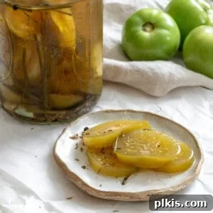 Tangy Green Tomatoes in a Flash 8 completed Quick Pickled Green Tomatoes plated alongside a jar of pickled tomatoes and raw green tomatoes