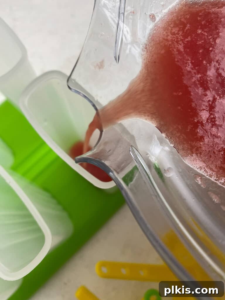 Sunshine Watermelon Pops 5 process of pouring watermelon mixture into mold