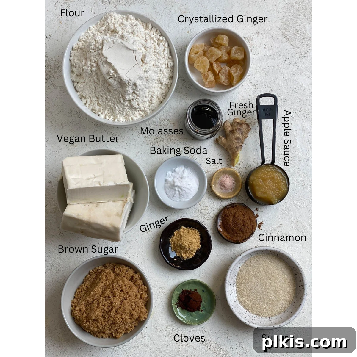Bold Triple Ginger Vegan Snaps 3 A collection of ingredients for Triple Ginger Cookies, meticulously measured and arranged on a pristine white surface, ready for baking.