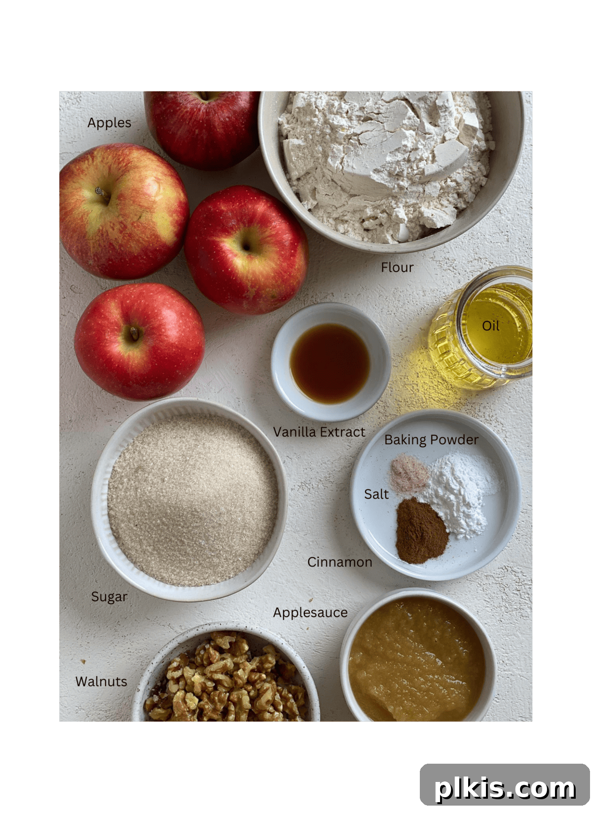Wholesome Vegan Apple Muffins 3 Ingredients for Vegan Apple Muffins measured out against a white surface, neatly arranged.