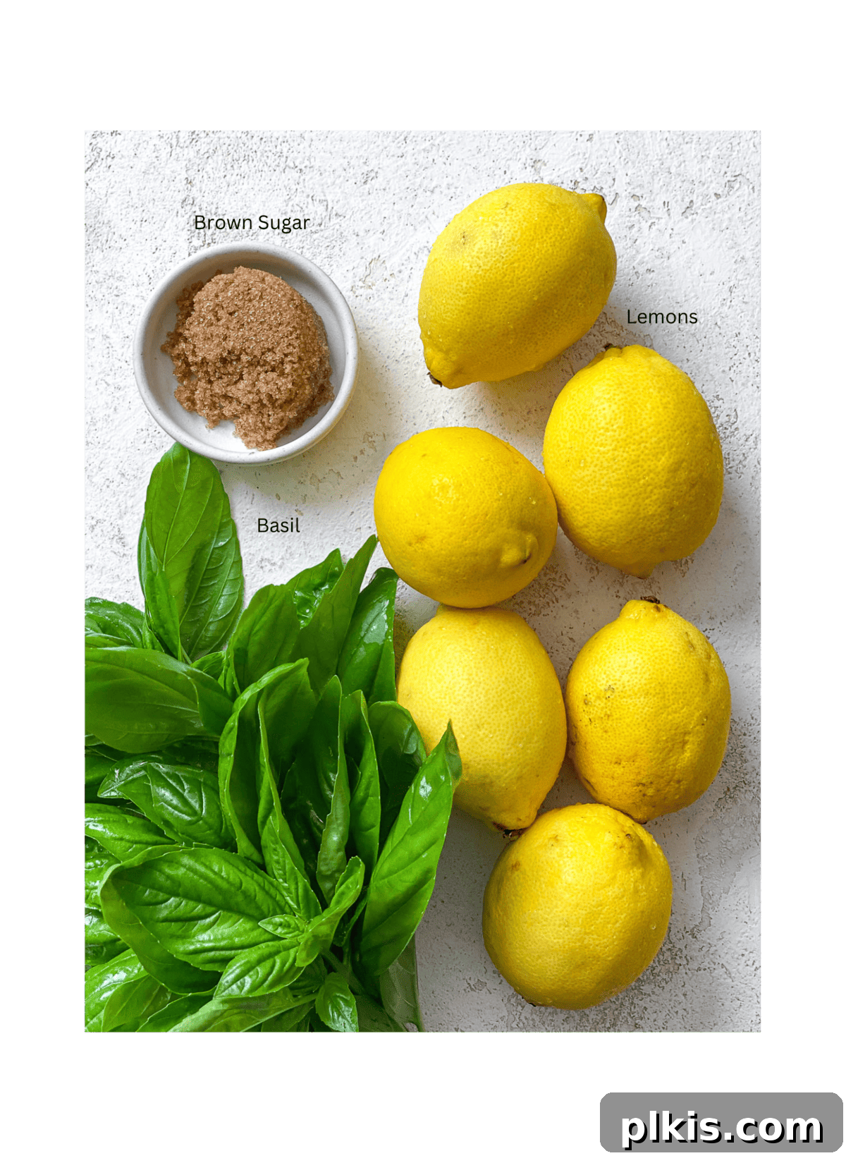 Basil Lemonade Creative Infusions 3 Ingredients for homemade basil lemonade, including fresh lemons, basil leaves, sugar, and water.