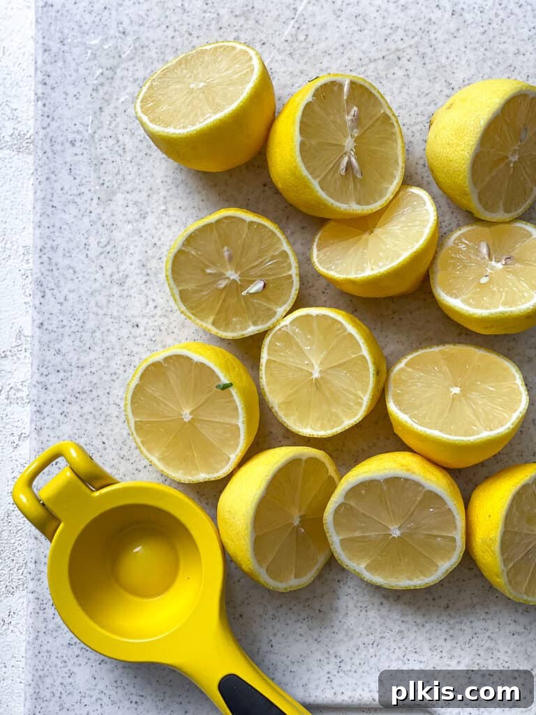 Basil Lemonade Creative Infusions 8 Sliced lemons arranged on a white surface, ready for juicing.