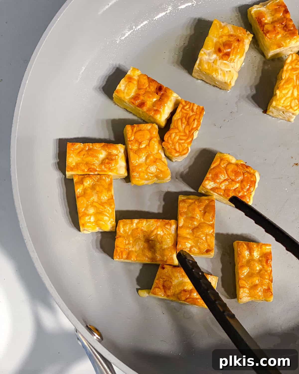 Simple Sizzling Tempeh 5 process shot of flipping tempeh in pan