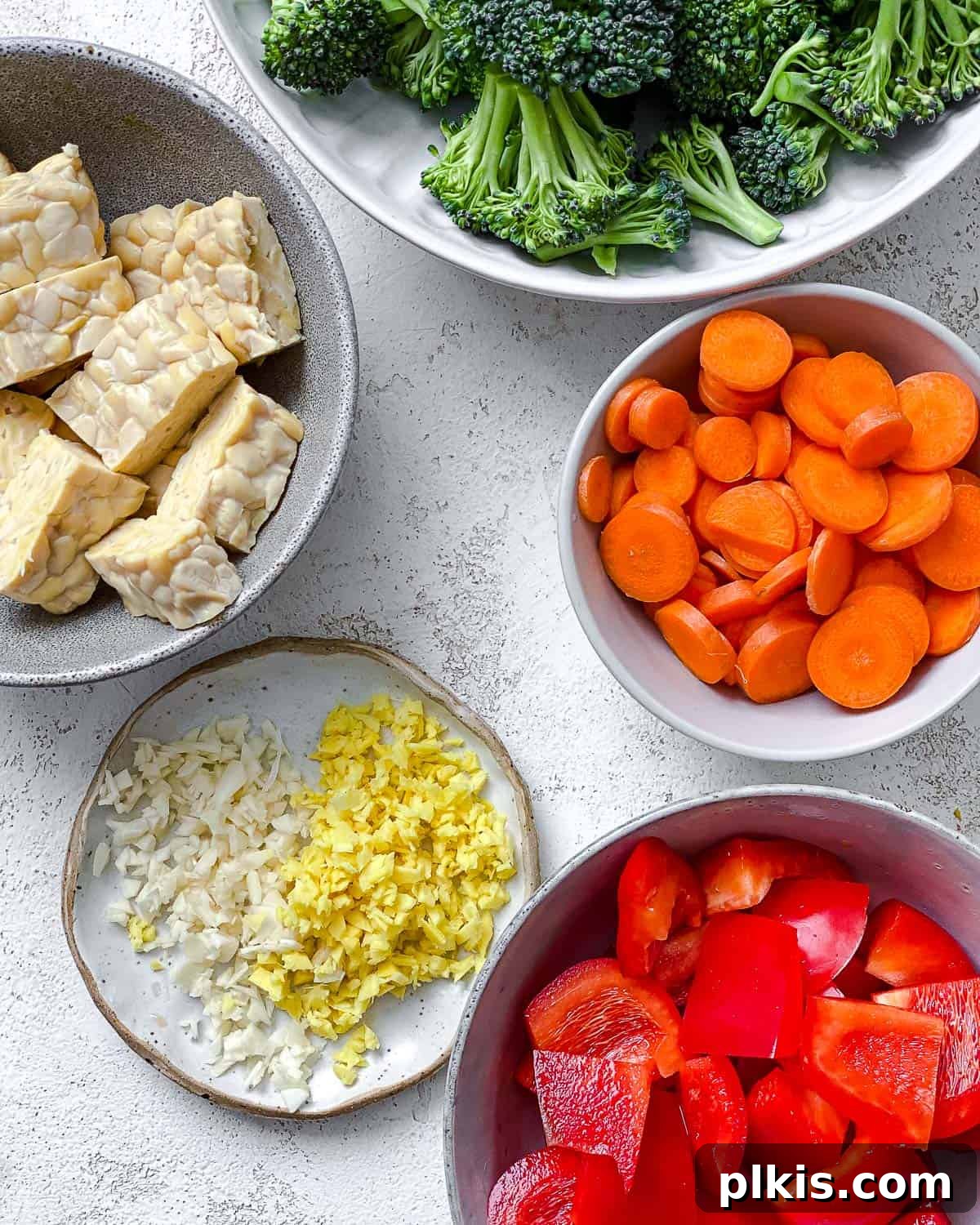 Simple Sizzling Tempeh 6 ingredients for Easy Tempeh Stir-Fry measured out against a white surface