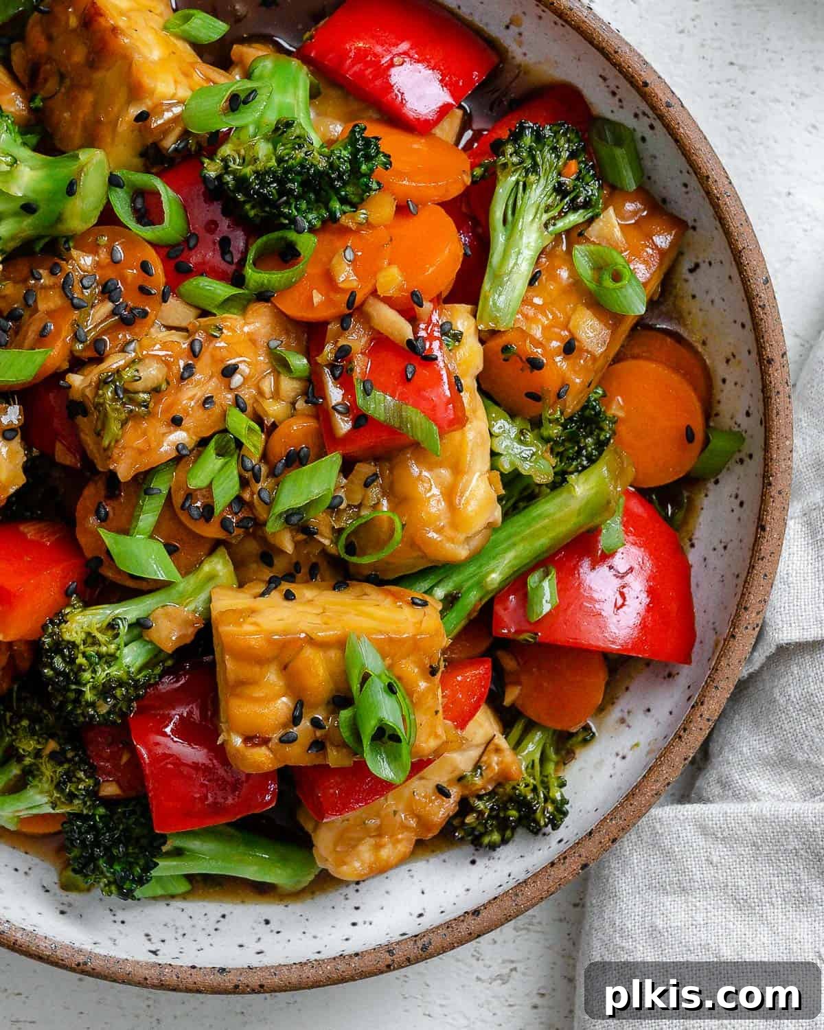 Simple Sizzling Tempeh 9 completed Easy Tempeh Stir-Fry plated on a white plate against a white surface