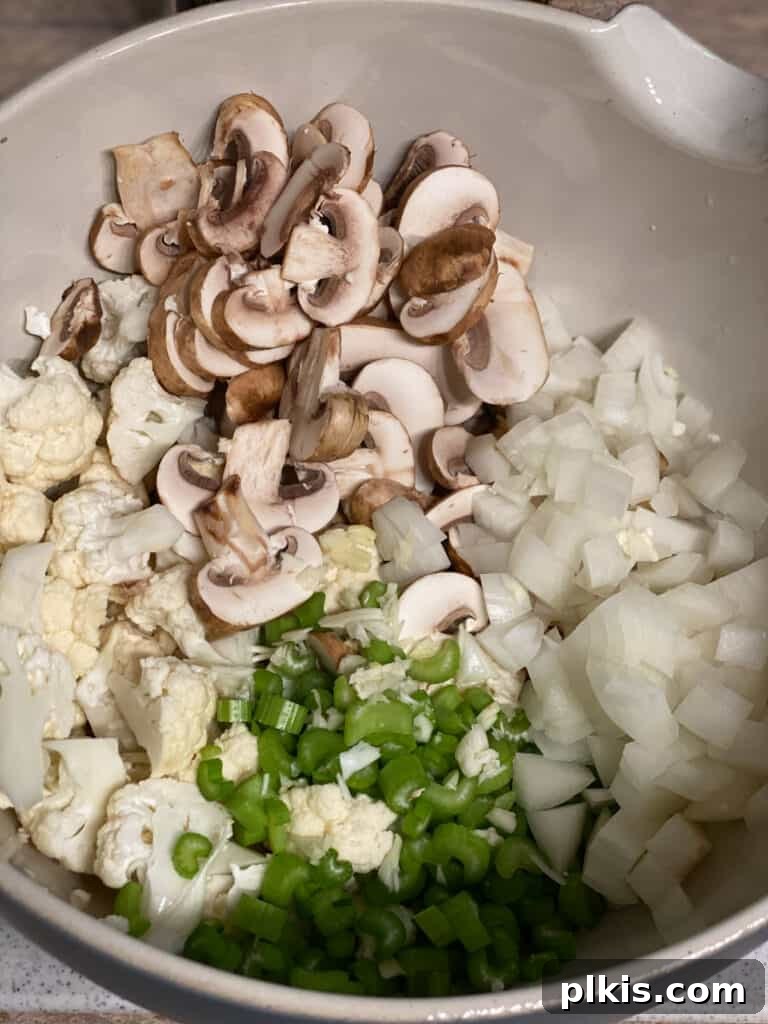 Irresistible Cauliflower Stuffing 4 process shot showing veggies in a bowl