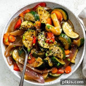 completed Easy Zucchini Stir Fry against a white surface