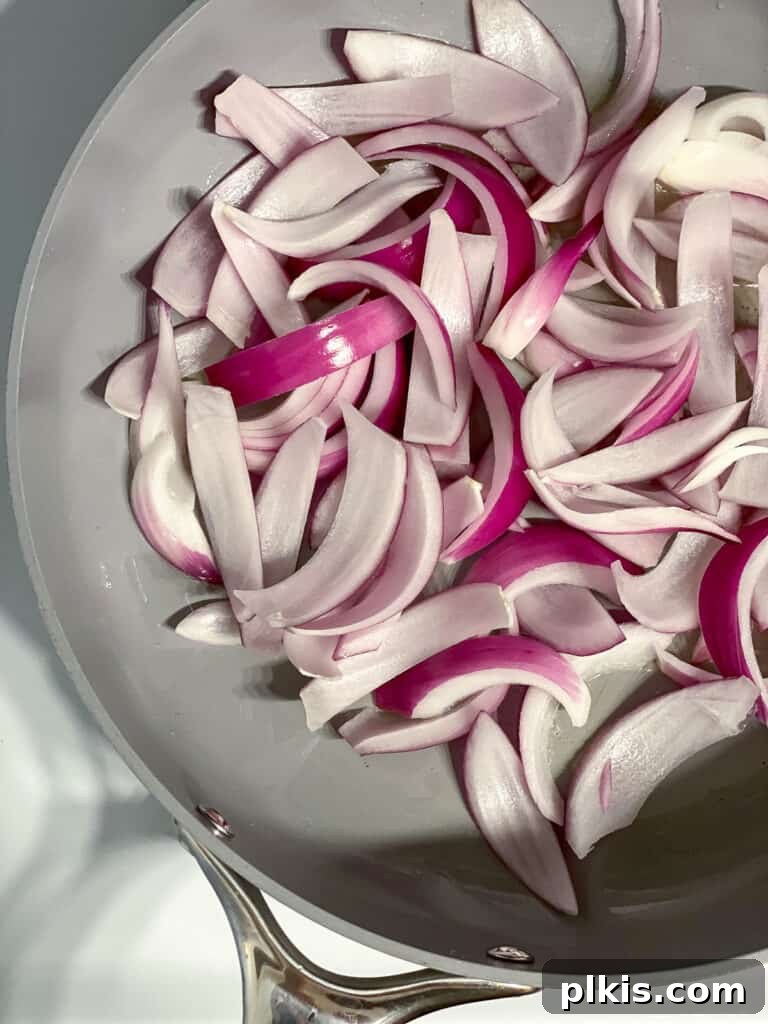 Speedy Zucchini Stir-Fry 6 Sliced red onions sizzling in hot oil in a large skillet, becoming tender and translucent.