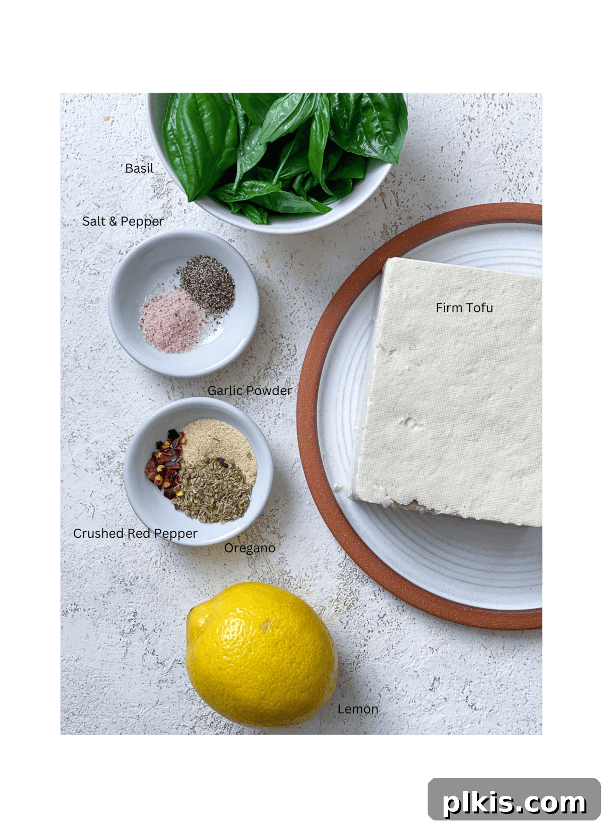 Creamy Vegan Tofu Ricotta 3 Ingredients for vegan tofu ricotta laid out on a white textured surface.