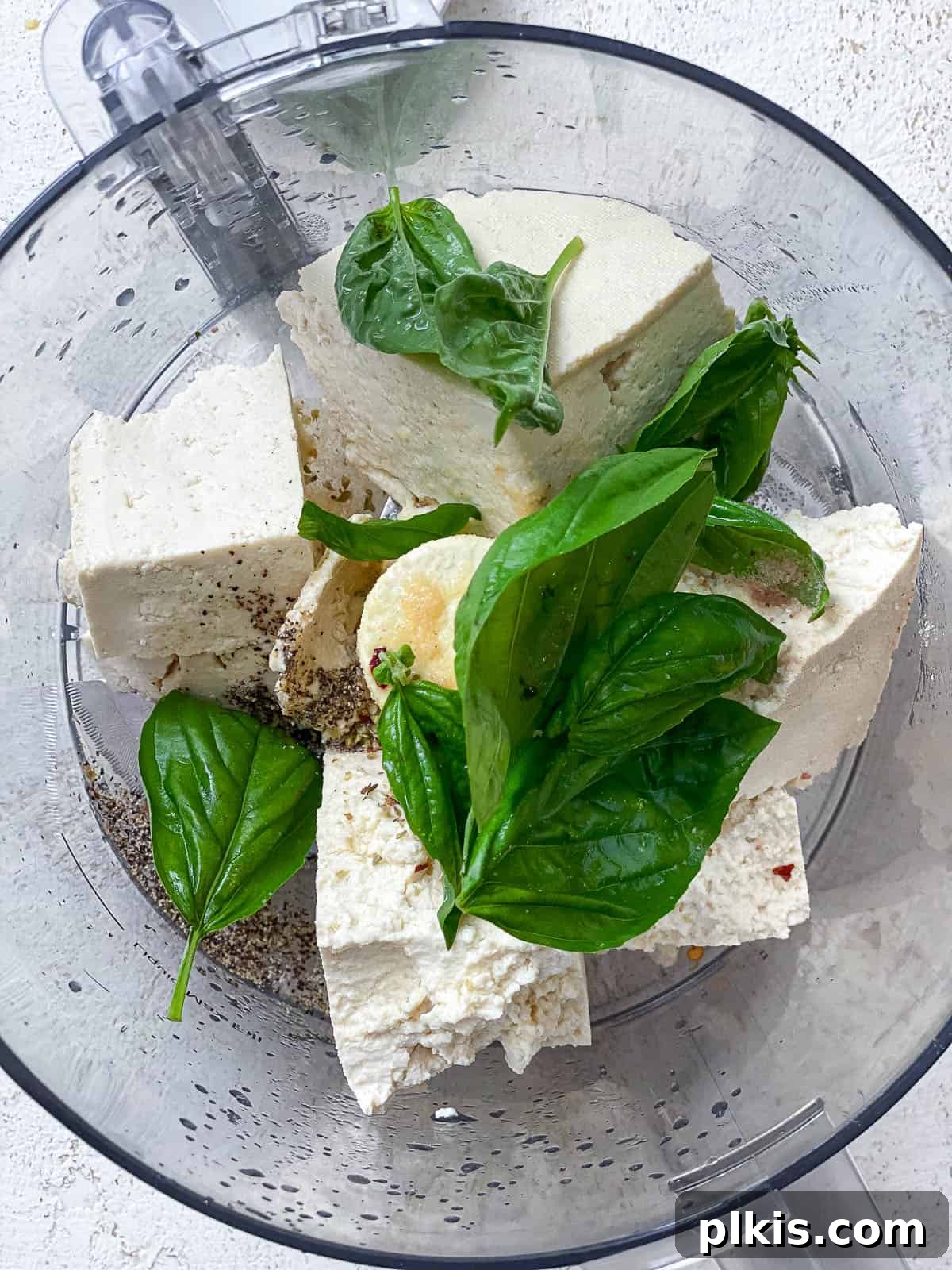 Creamy Vegan Tofu Ricotta 5 All the ingredients for Tofu Ricotta in the bowl of a food processor.