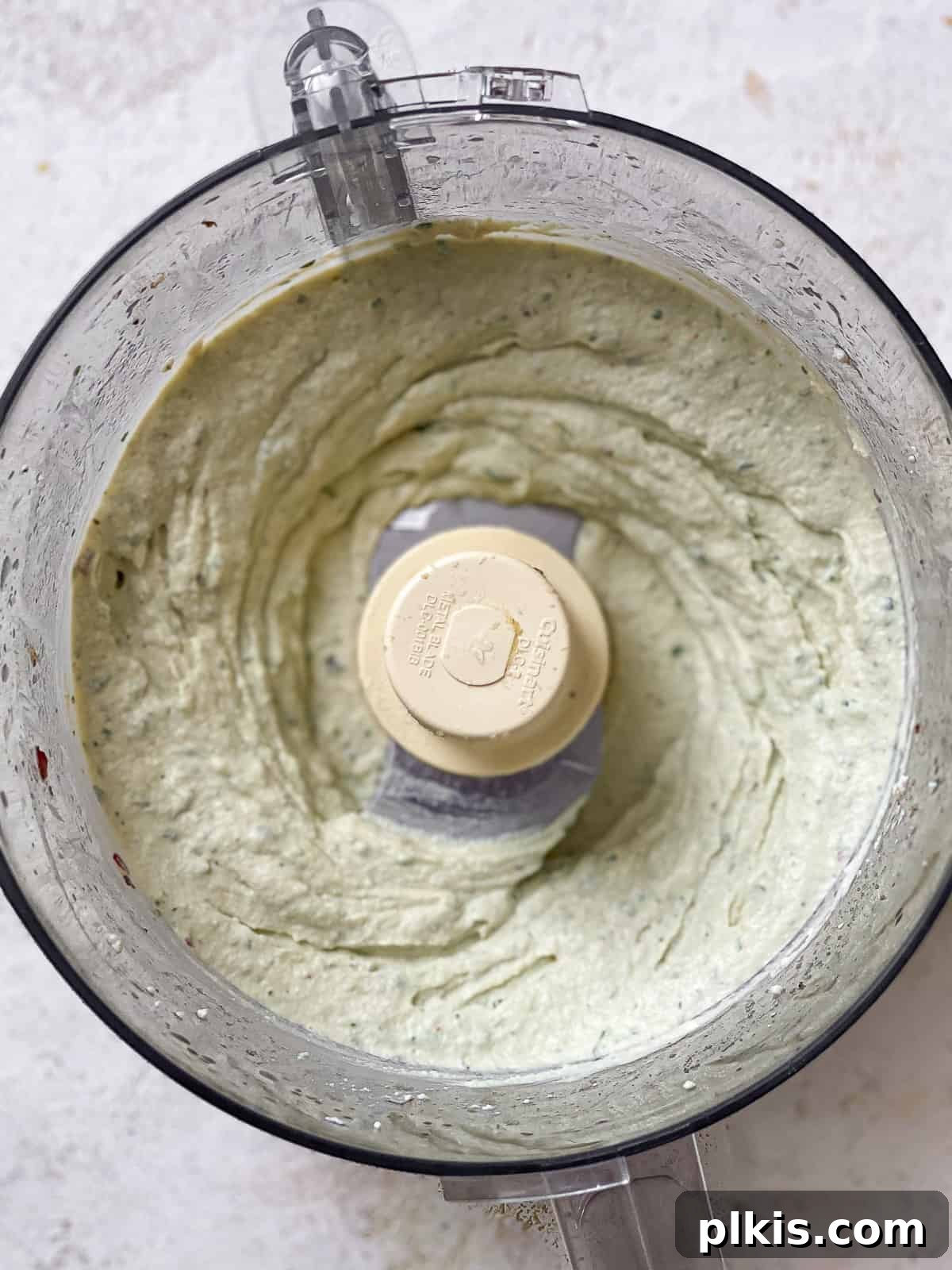 Creamy Vegan Tofu Ricotta 6 Freshly pureed tofu ricotta in the bowl of a food processor.