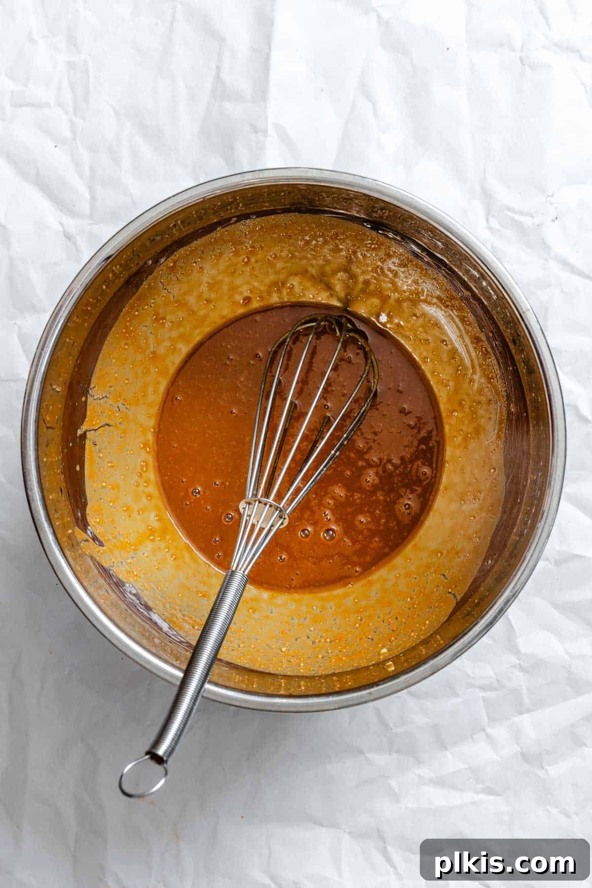 Golden Crispy Tofu with Rich Peanut Sauce 7 Process shot showing peanut sauce being whisked in a bowl.