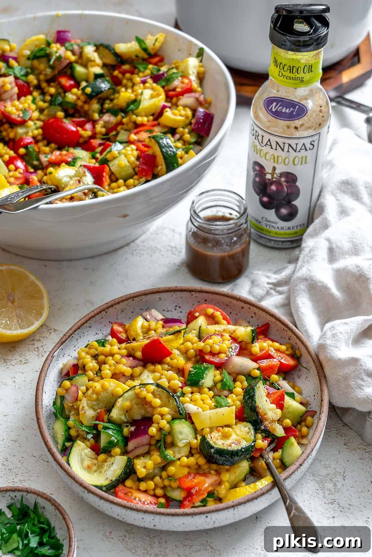 Vibrant Garden Couscous Salad 18 Two bowls of completed Couscous Salad with Roasted Vegetables presented on a white background.