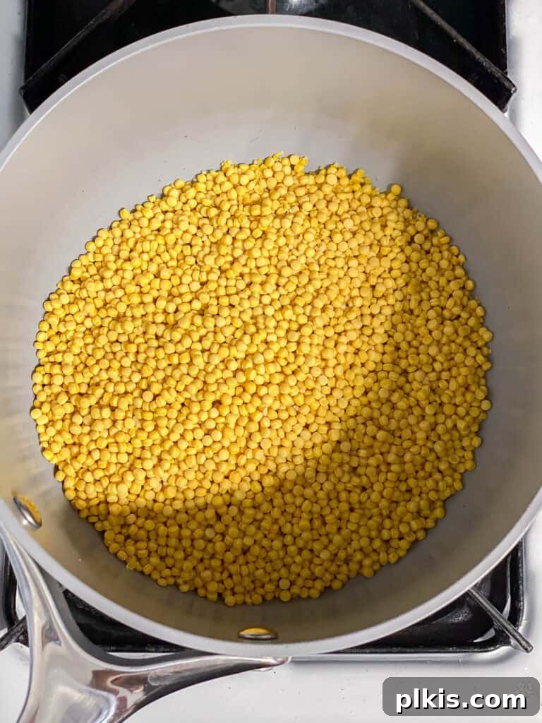 Vibrant Garden Couscous Salad 4 Uncooked pearl couscous in a pot, ready for cooking.