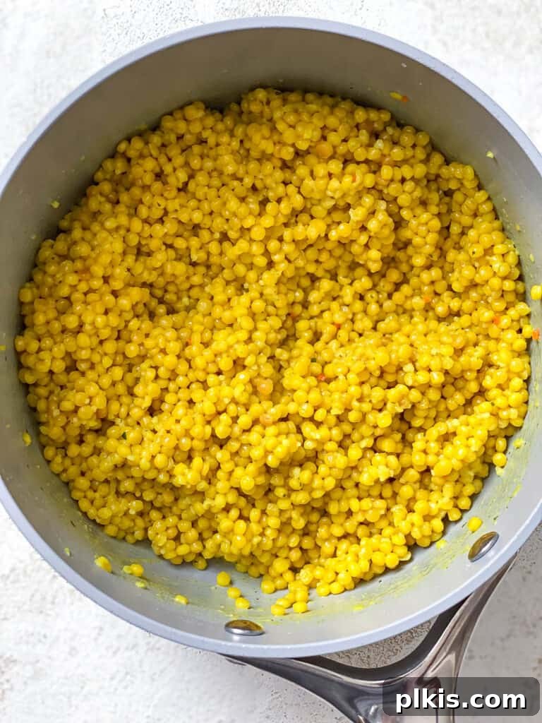 Vibrant Garden Couscous Salad 6 Cooked, fluffy pearl couscous in a pot, ready for the salad.