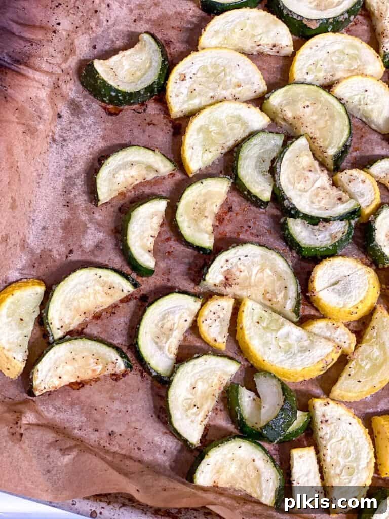 Vibrant Garden Couscous Salad 9 Roasted zucchini and summer squash on a baking tray, perfectly cooked.