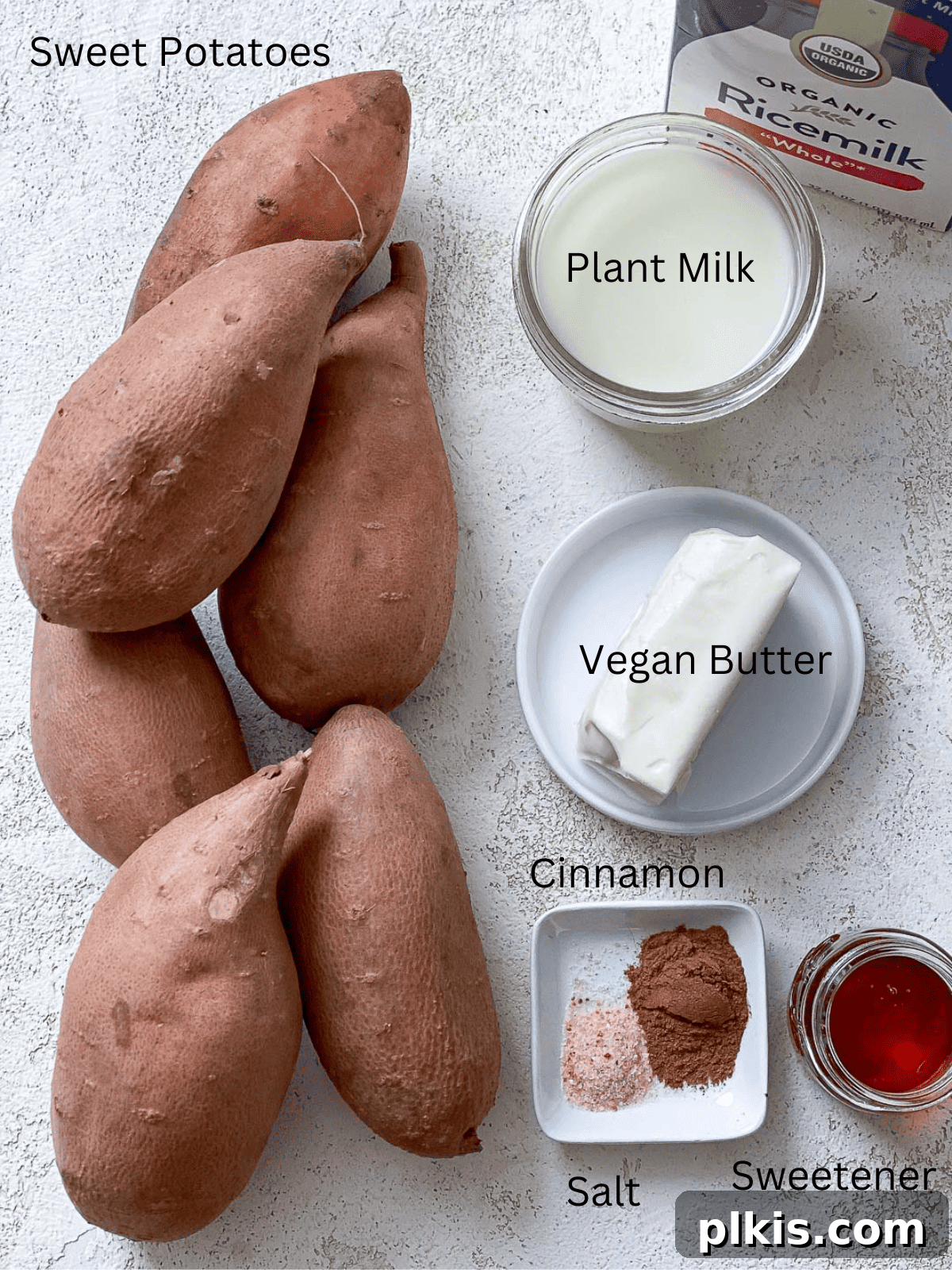 Velvety Vegan Sweet Potato Mash 3 A flat lay photograph showcasing the ingredients for making mashed sweet potatoes, including whole sweet potatoes, plant-based milk, vegan butter, and spices.