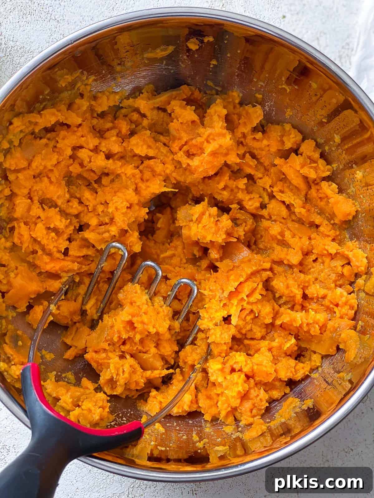 Velvety Vegan Sweet Potato Mash 7 Cooked sweet potatoes after being mashed into a smooth, creamy texture in a bowl.
