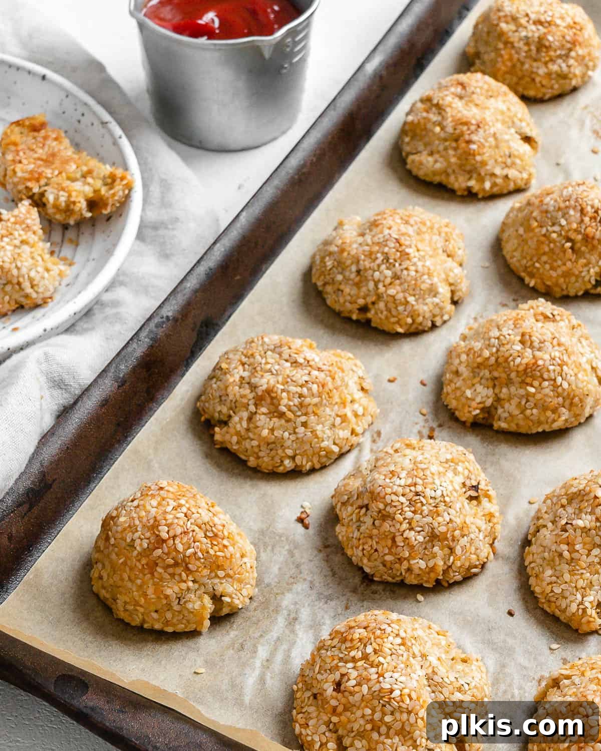 30 Effortless Plant-Based Potato Creations 9 completed Sesame Potato Puffs on a baking tray