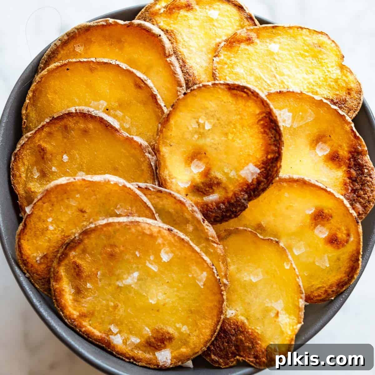 30 Effortless Plant-Based Potato Creations 17 completed Homemade Potato Chips on a white surface