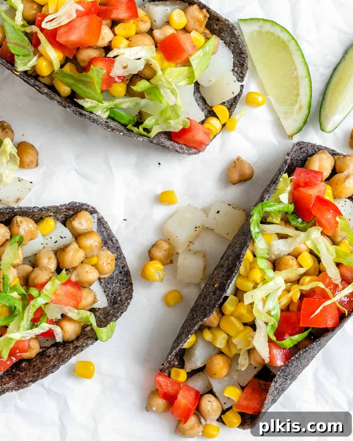 30 Effortless Plant-Based Potato Creations 18 three completed Potato and Chickpea Tacos on a white surface