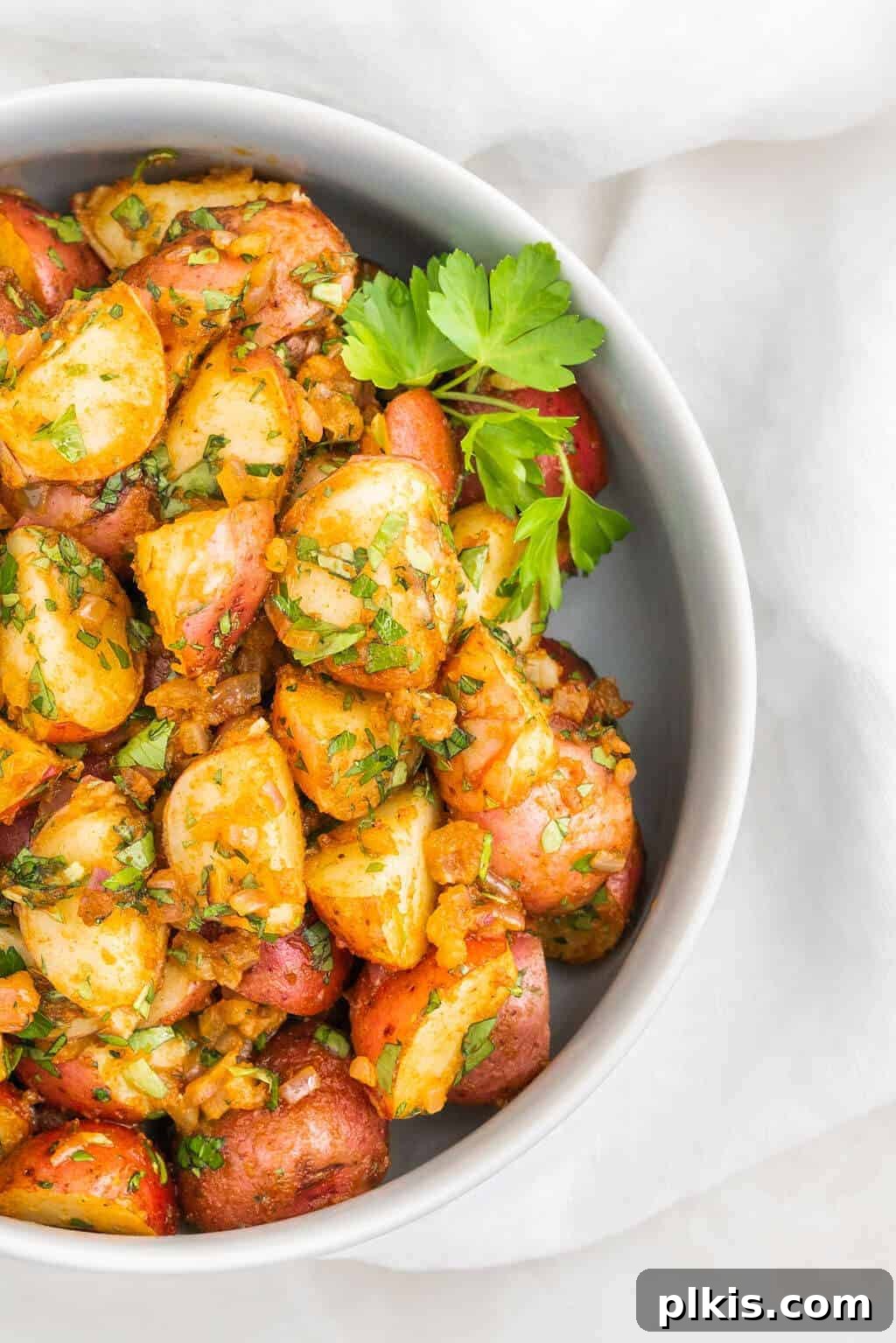 30 Effortless Plant-Based Potato Creations 3 completed French potato salad in a white container