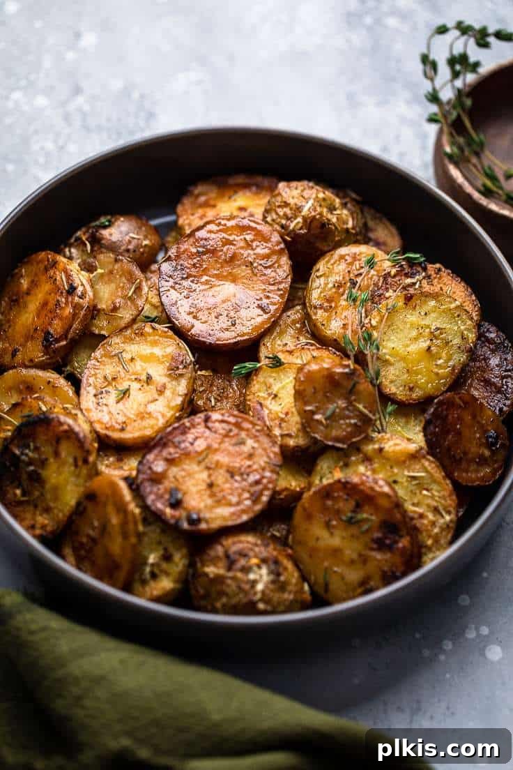 30 Effortless Plant-Based Potato Creations 22 completed Lemon and Rosemary Melting Potatoes in a black plate