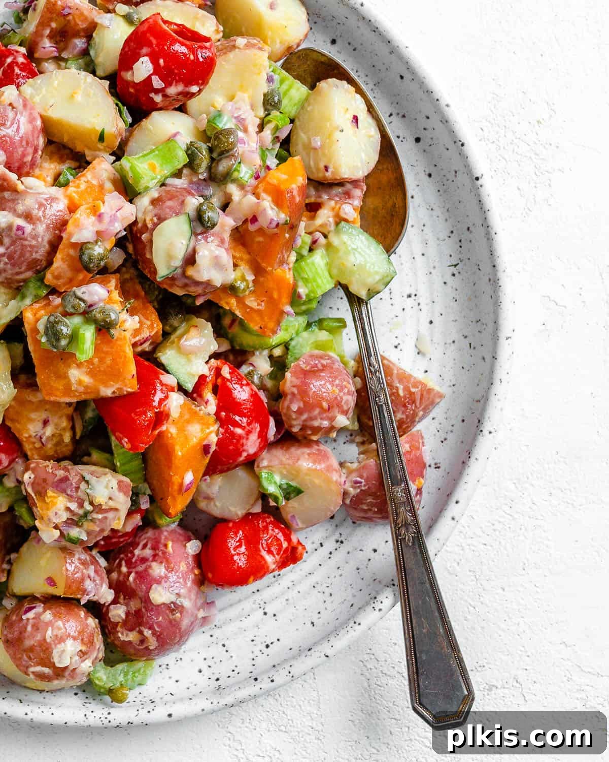 30 Effortless Plant-Based Potato Creations 25 completed Sweet Potato Salad in a white bowl against a white surface