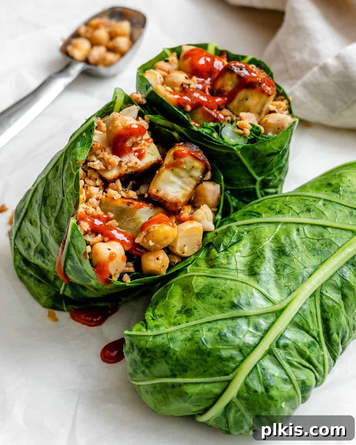 30 Effortless Plant-Based Potato Creations 28 two completed Collard Green Wraps with one halved against a light background