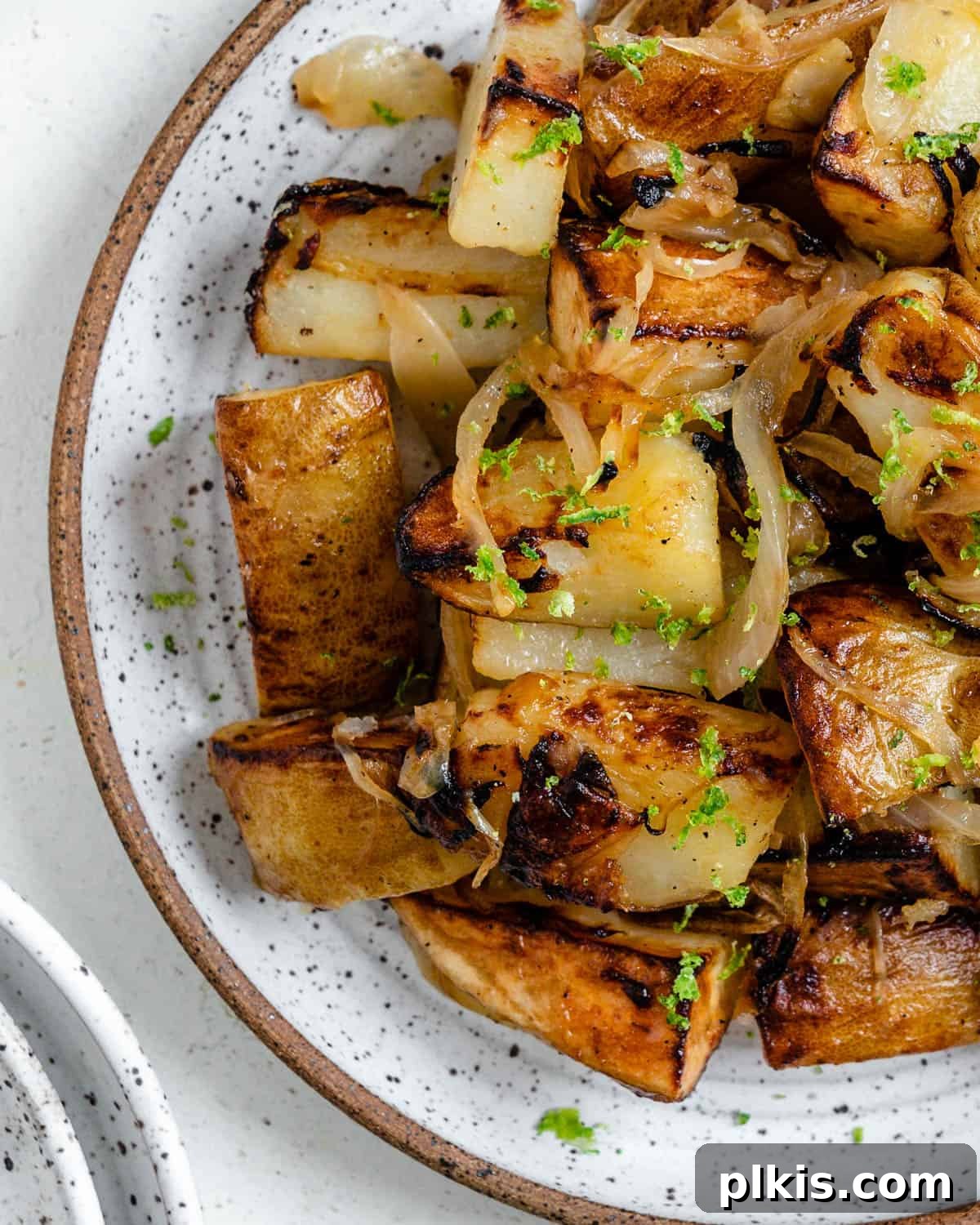 30 Effortless Plant-Based Potato Creations 29 completed Crispy Home Fries plated on a white plate