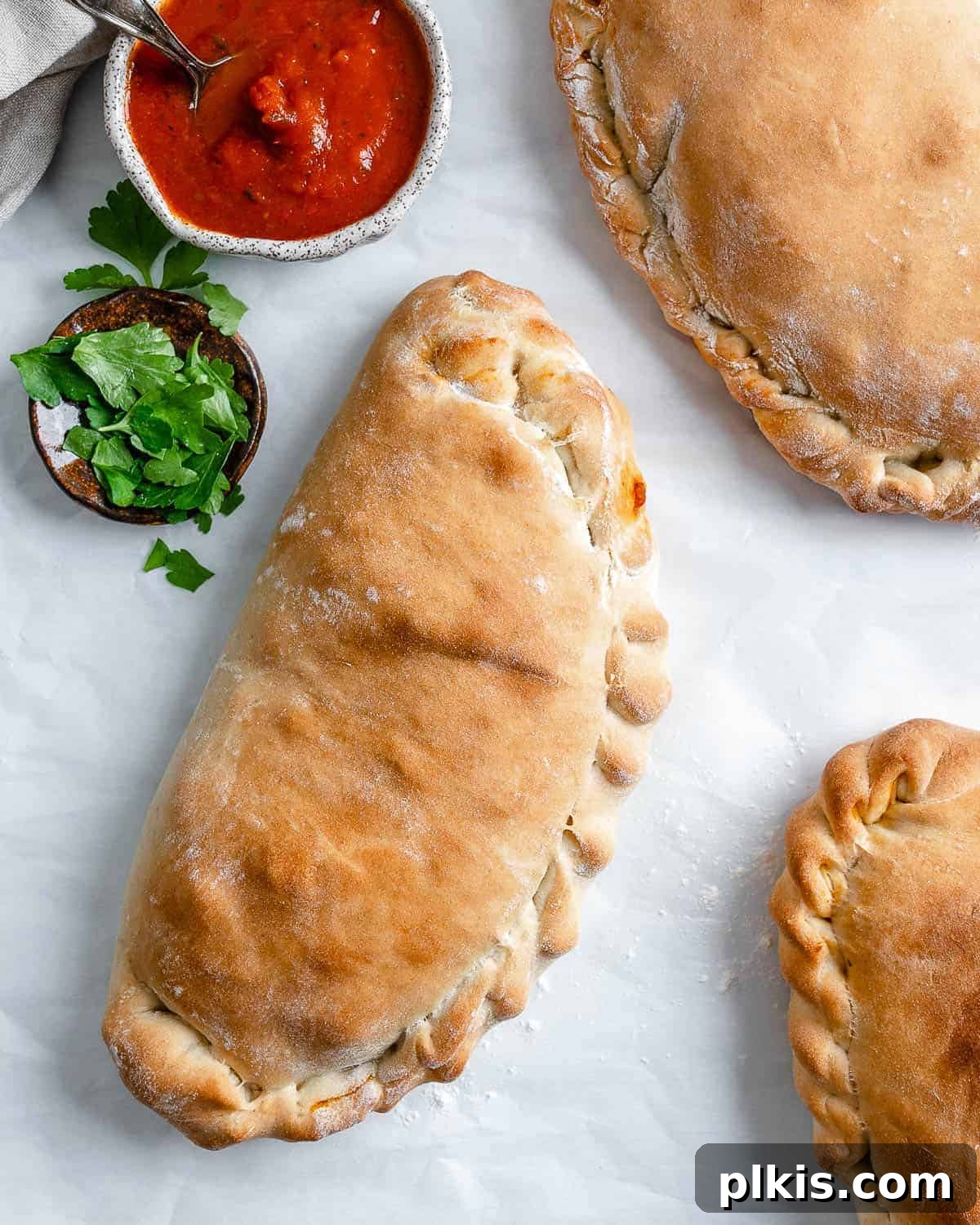 Perfect Vegan Calzones with Homemade Pizza Dough 2 three completed completed Marinara Calzones against white surface