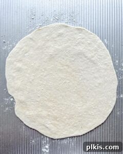 Perfect Vegan Calzones with Homemade Pizza Dough 13 rolled out dough against gray surface