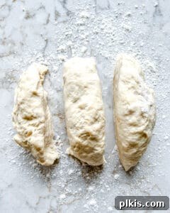 Perfect Vegan Calzones with Homemade Pizza Dough 10 process of splitting dough into three separate pieces