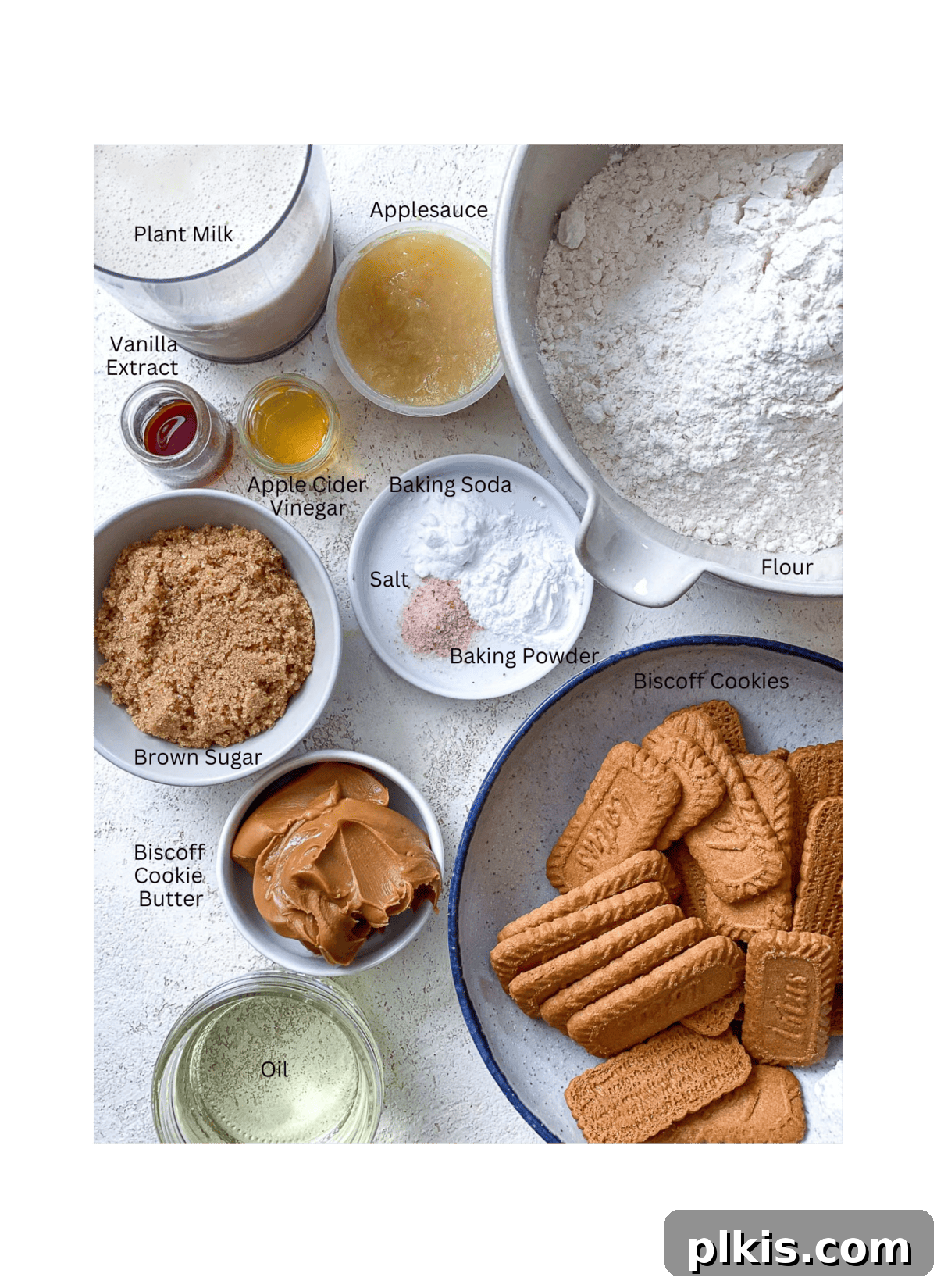 Decadent Vegan Biscoff Dream 3 ingredients for Vegan Biscoff Cake against a white surface, neatly arranged