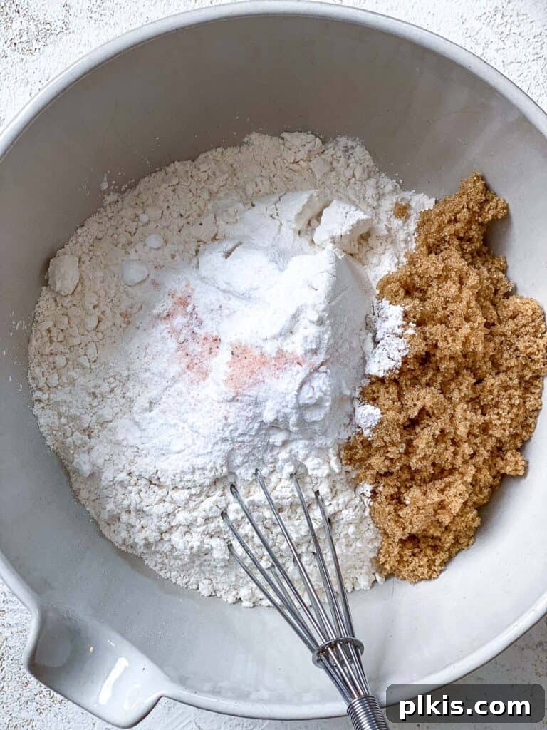 Decadent Vegan Biscoff Dream 7 process shot of mixing ingredients together in a bowl, whisking dry ingredients