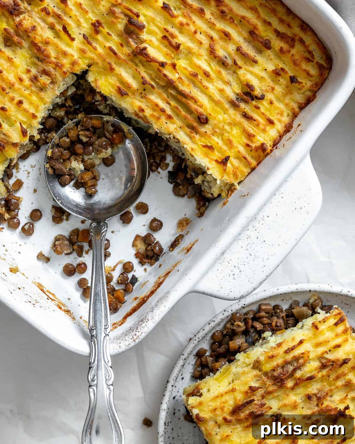 Wholesome Lentil Shepherd's Comfort 2 A beautifully baked vegan lentil shepherd's pie, golden brown on top, with a rich, savory filling visible, ready to be served for a hearty meal.