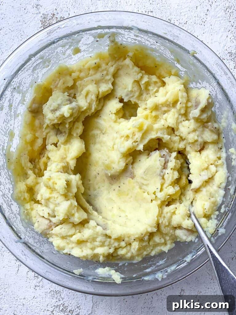 Wholesome Lentil Shepherd's Comfort 17 Smooth and creamy mashed potato mixture in a bowl, perfectly seasoned and ready.