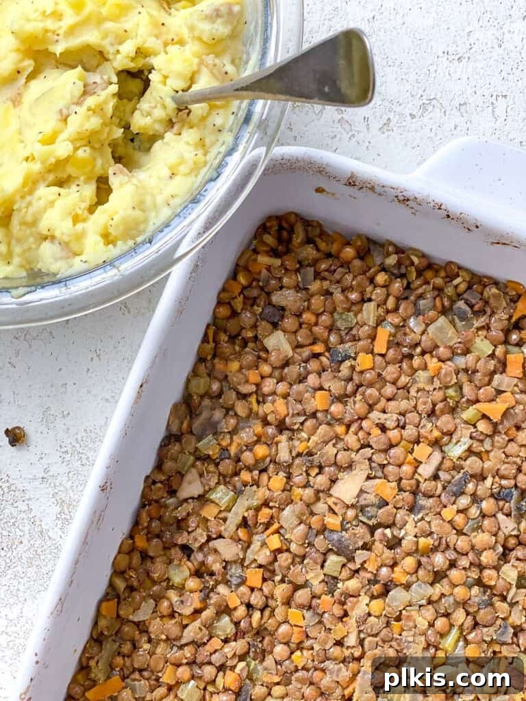 Wholesome Lentil Shepherd's Comfort 18 A casserole dish filled with the savory lentil and vegetable filling, ready for the potato topping.