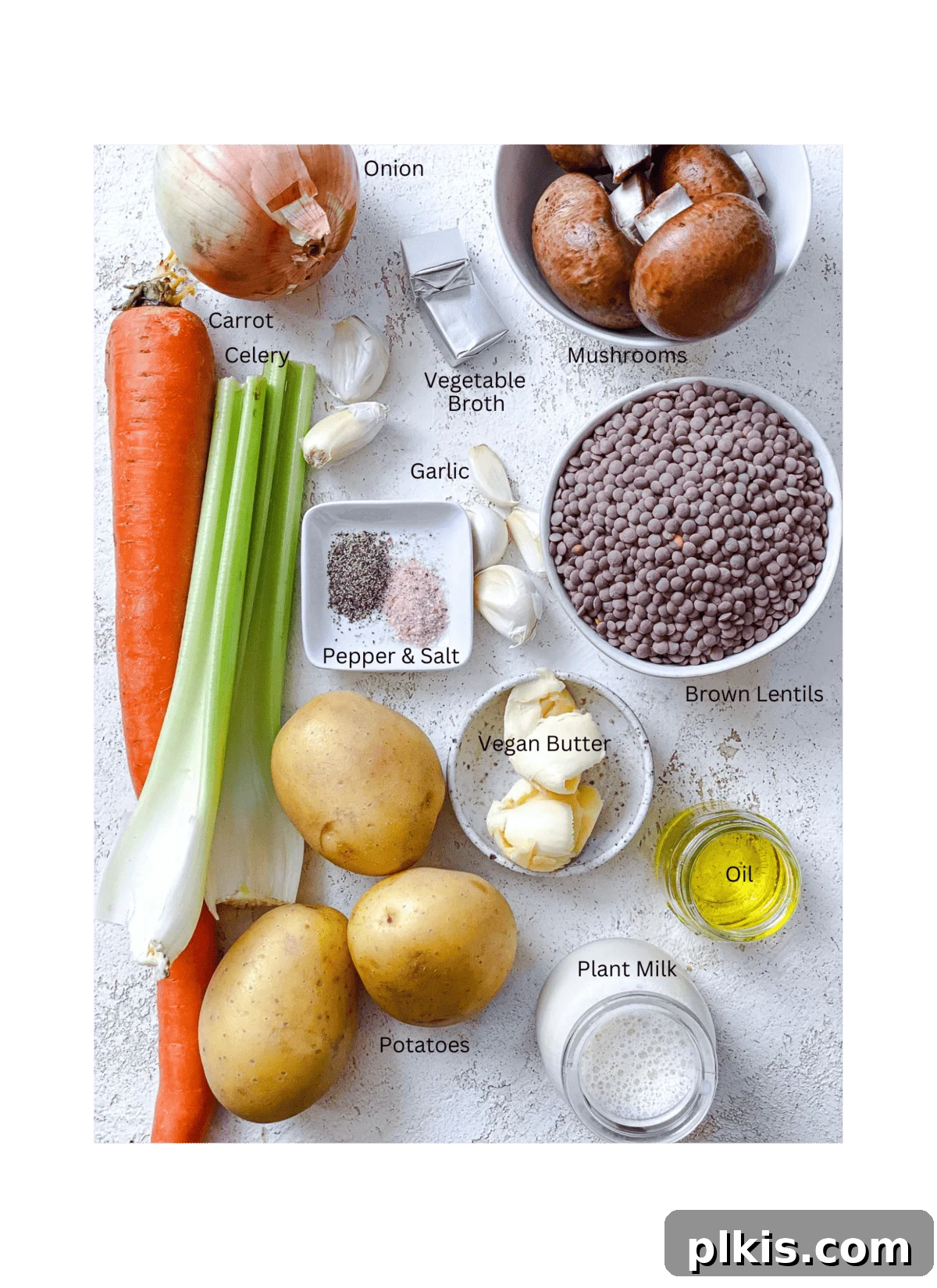 Wholesome Lentil Shepherd's Comfort 3 A vibrant assortment of fresh ingredients laid out, including potatoes, carrots, celery, onions, garlic, lentils, and mushrooms, ready for a delicious vegan lentil shepherd's pie.