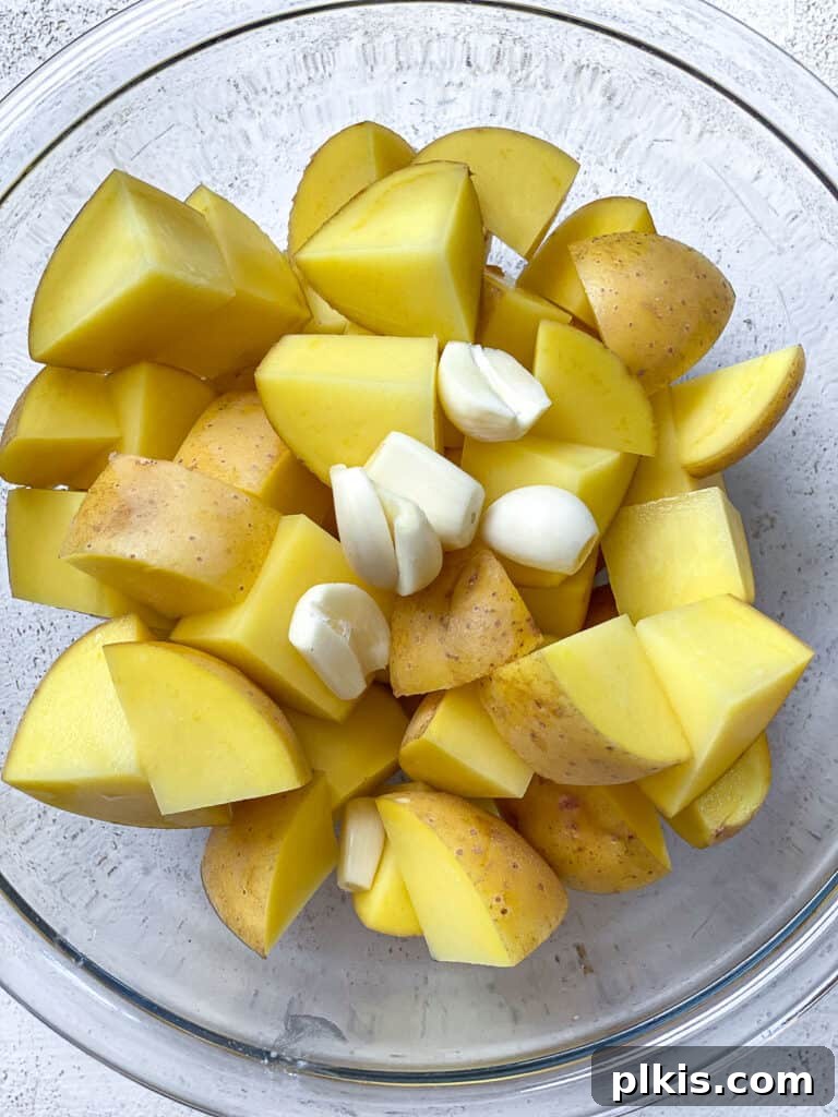 Wholesome Lentil Shepherd's Comfort 5 Diced potatoes soaking in water, a crucial step to remove excess starch for fluffier mash.