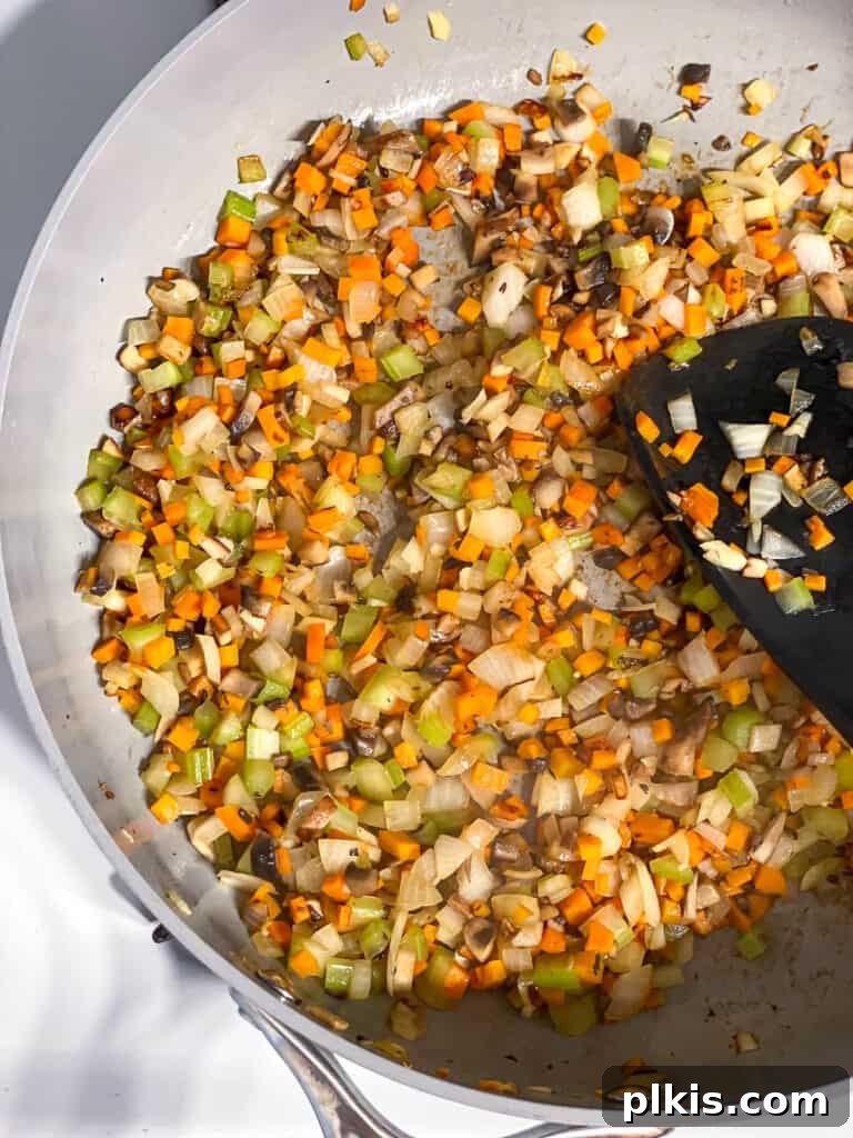 Wholesome Lentil Shepherd's Comfort 10 Sautéed vegetables in a pan, lightly browned and fragrant, forming the base of the filling.