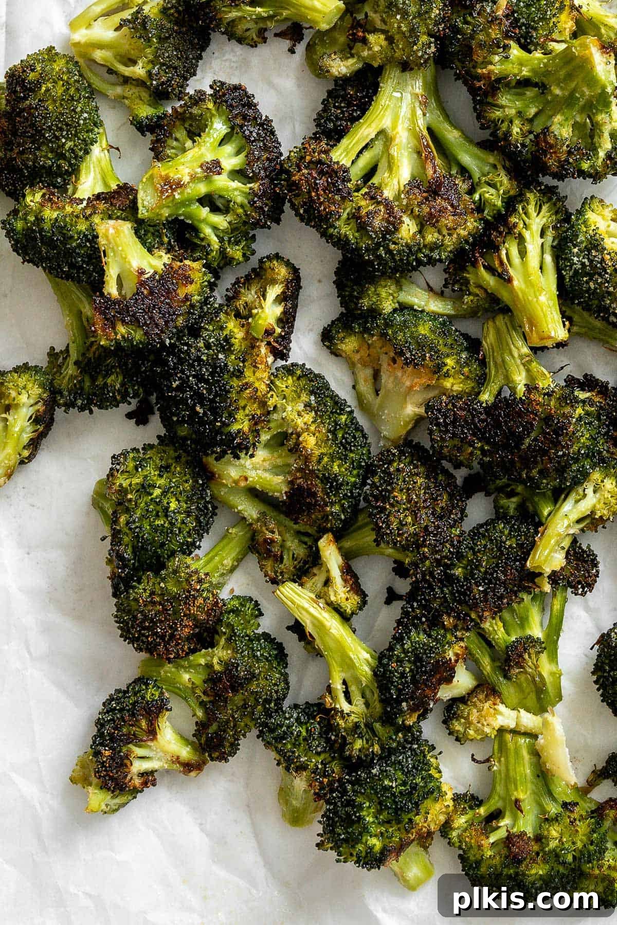Blistered Oven Broccoli 2 completed Oven Charred Broccoli on a white surface