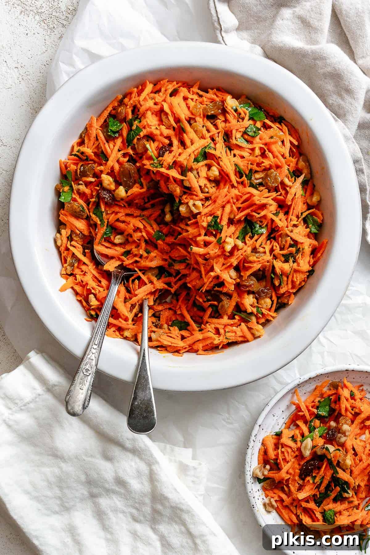 Sweet and Crunchy Carrot Raisin Medley 2 completed Healthy Carrot Raisin Salad in a white bowl