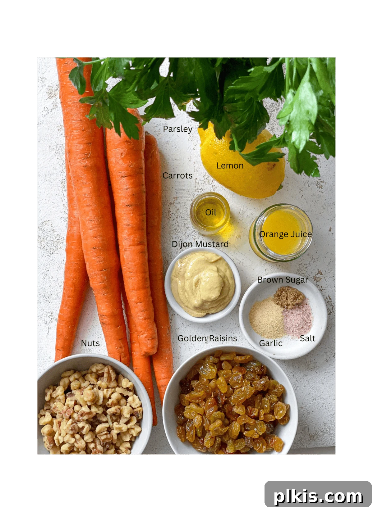 Sweet and Crunchy Carrot Raisin Medley 3 ingredients for Healthy Carrot Raisin Salad measured out against a white surface