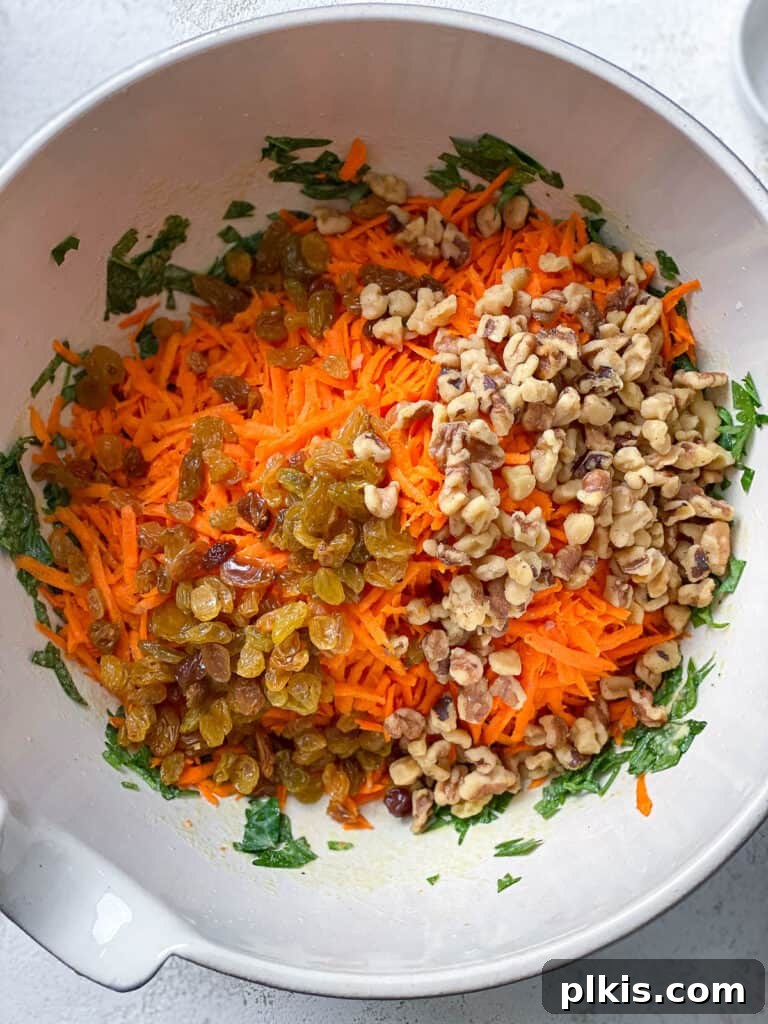 Sweet and Crunchy Carrot Raisin Medley 7 process shot of adding additional ingredients to bowl