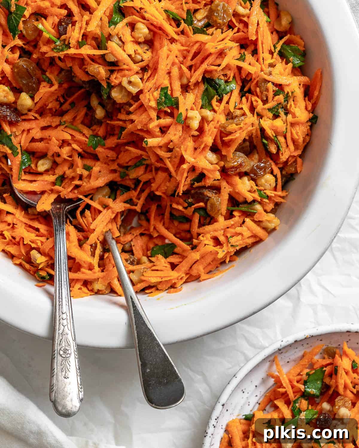 Sweet and Crunchy Carrot Raisin Medley 8 completed Healthy Carrot Raisin Salad in a white bowl