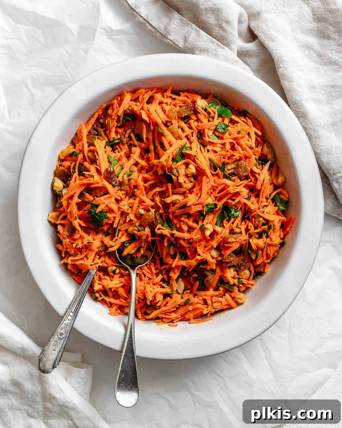 Sweet and Crunchy Carrot Raisin Medley 9 completed Healthy Carrot Raisin Salad in a white bowl