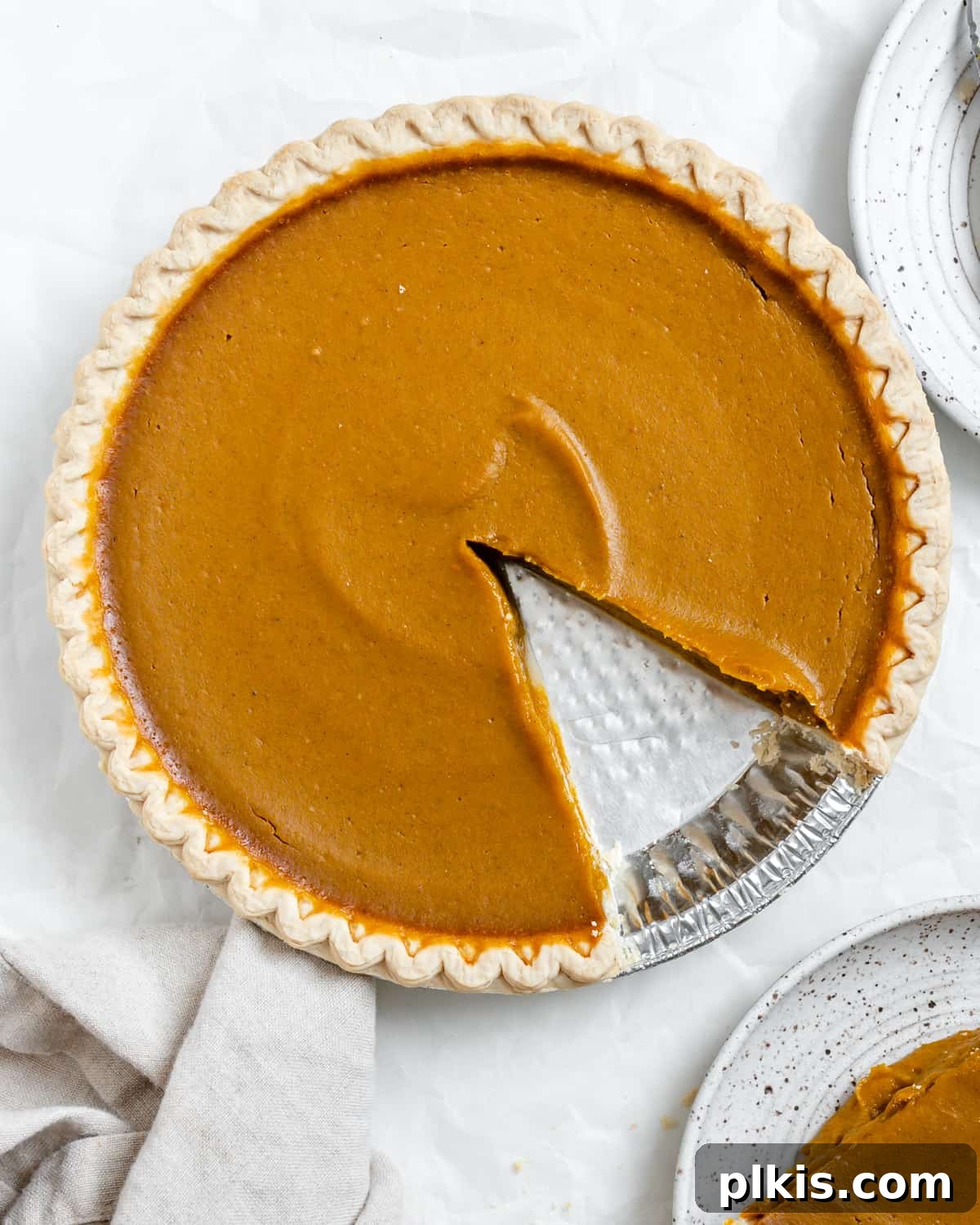 Effortless Vegan Pumpkin Perfection 2 completed Easy Vegan Pumpkin Pie with a piece plated on the side