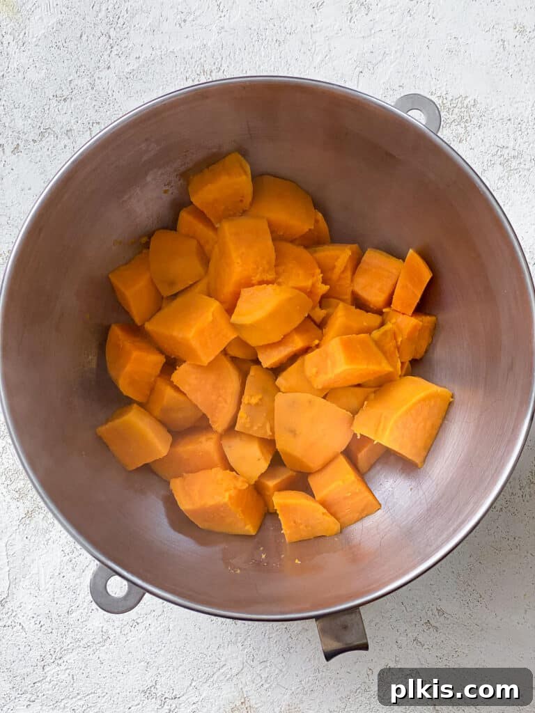 Creamy Vegan Sweet Potato Dream 7 Soft, drained sweet potatoes in a mixing bowl, ready to be mashed or pureed.