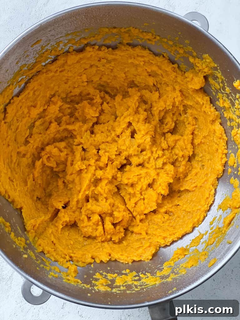 Creamy Vegan Sweet Potato Dream 8 Creamy, mashed sweet potatoes in a pot after being thoroughly pureed, showcasing a smooth texture.